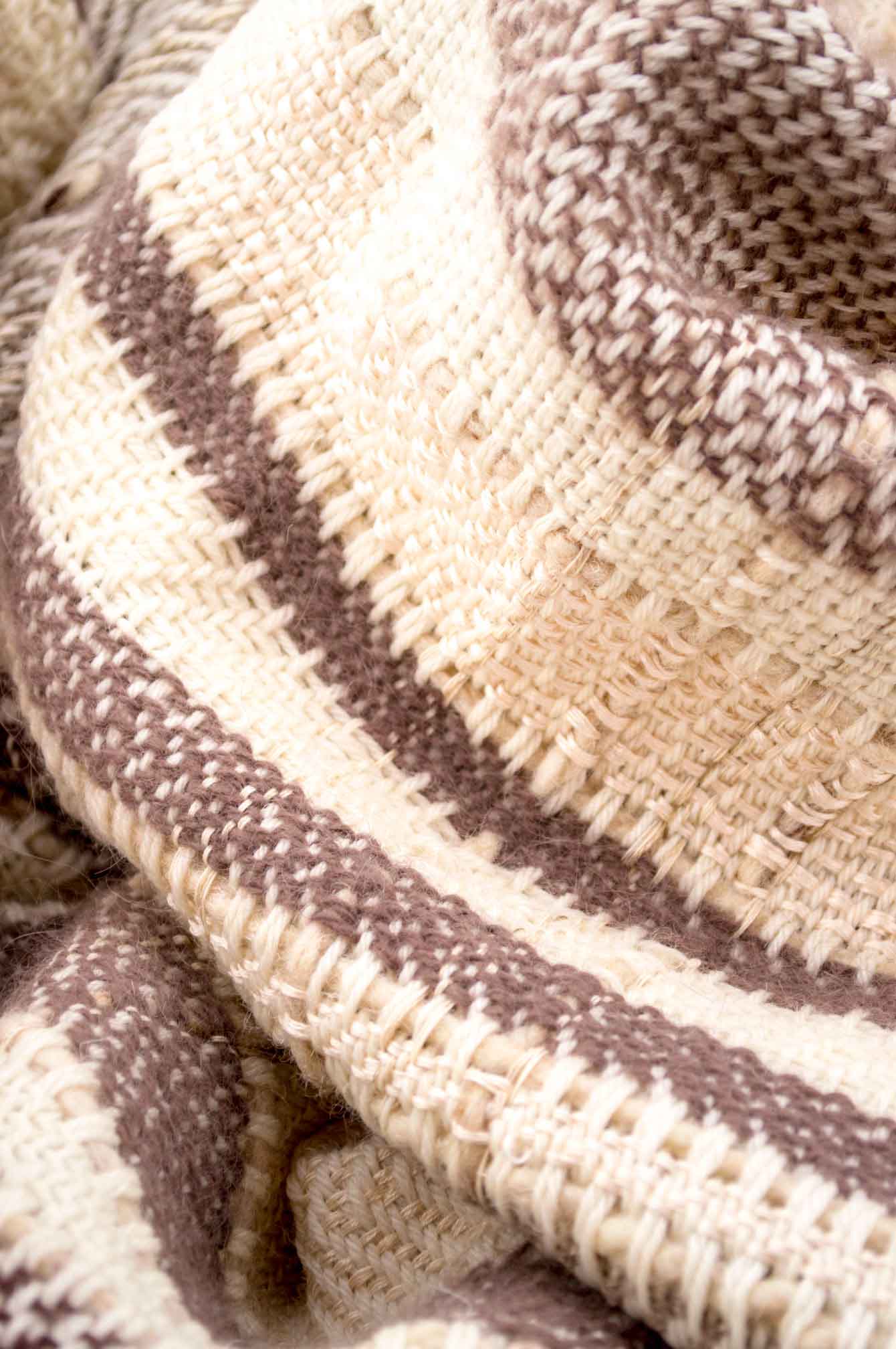Throw blanket created with brown and taupe angora wood, pinky beige silk floss, silk, cashmere, country wool, ecru wool, and beige cotton threads slipped into the plaid.   Technique: Throw blanket hand-woven in a traditional way on non-mechanical looms in the 7th arrondissement of Paris in France.  Finishes: Right edge. Double stitching.  Size: 145 x 180 cm.  Single piece / 1 copy only.